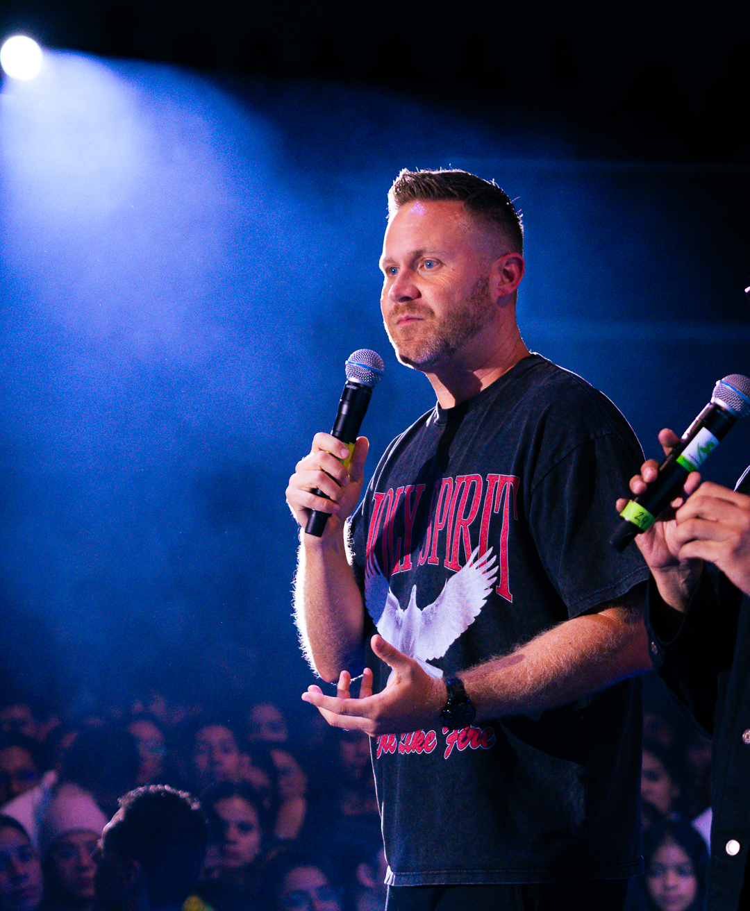 Jason Parks speaking at a ministry event with a crowd