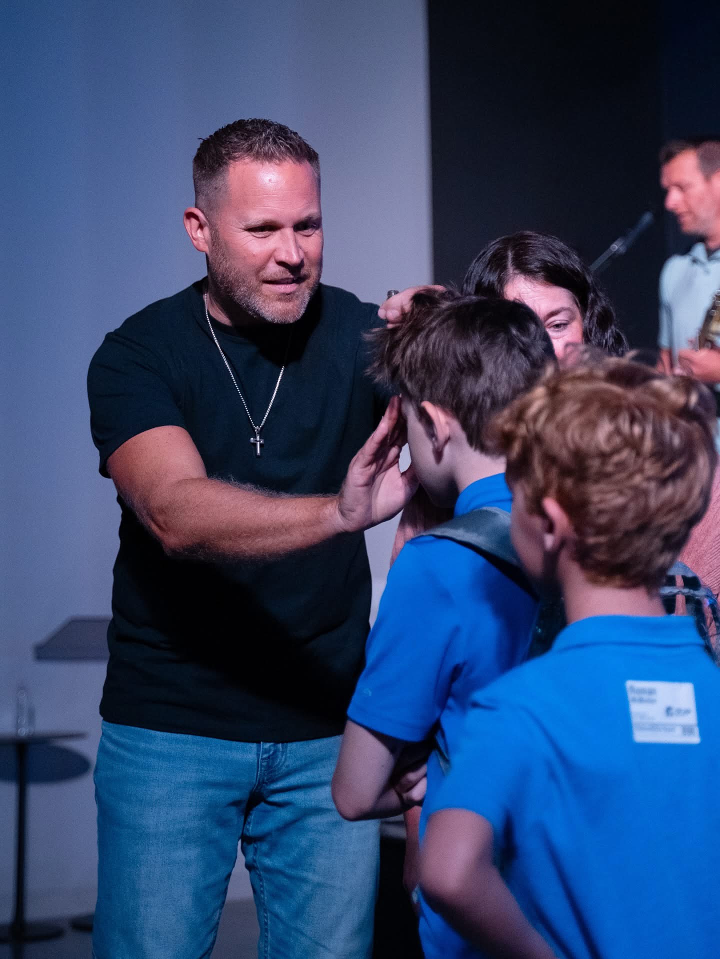 Jason Parks praying with people after a message