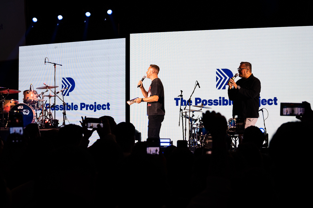 Jason Parks speaking to a large crowd at a conference